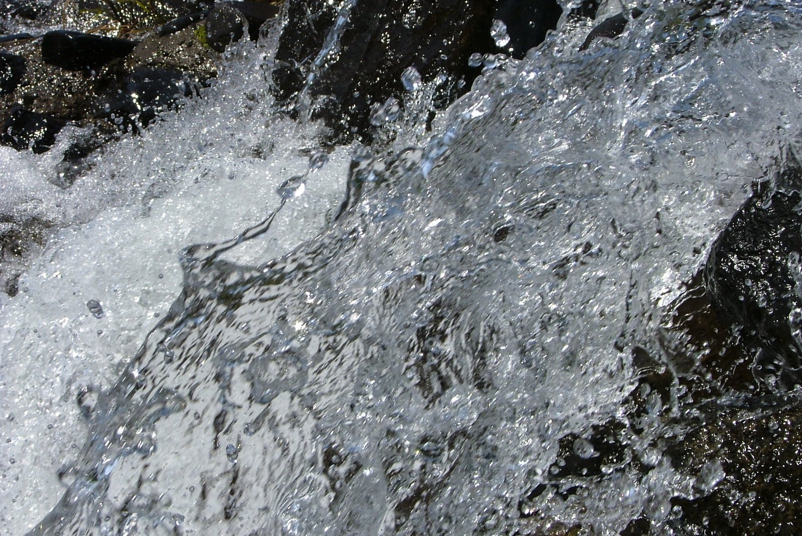 there is soing splashing out of a rushing water