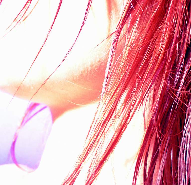 an angled view of someones red hair and eyeglasses