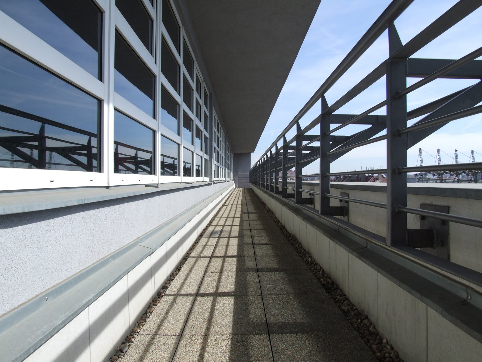 an image of long walkway between buildings