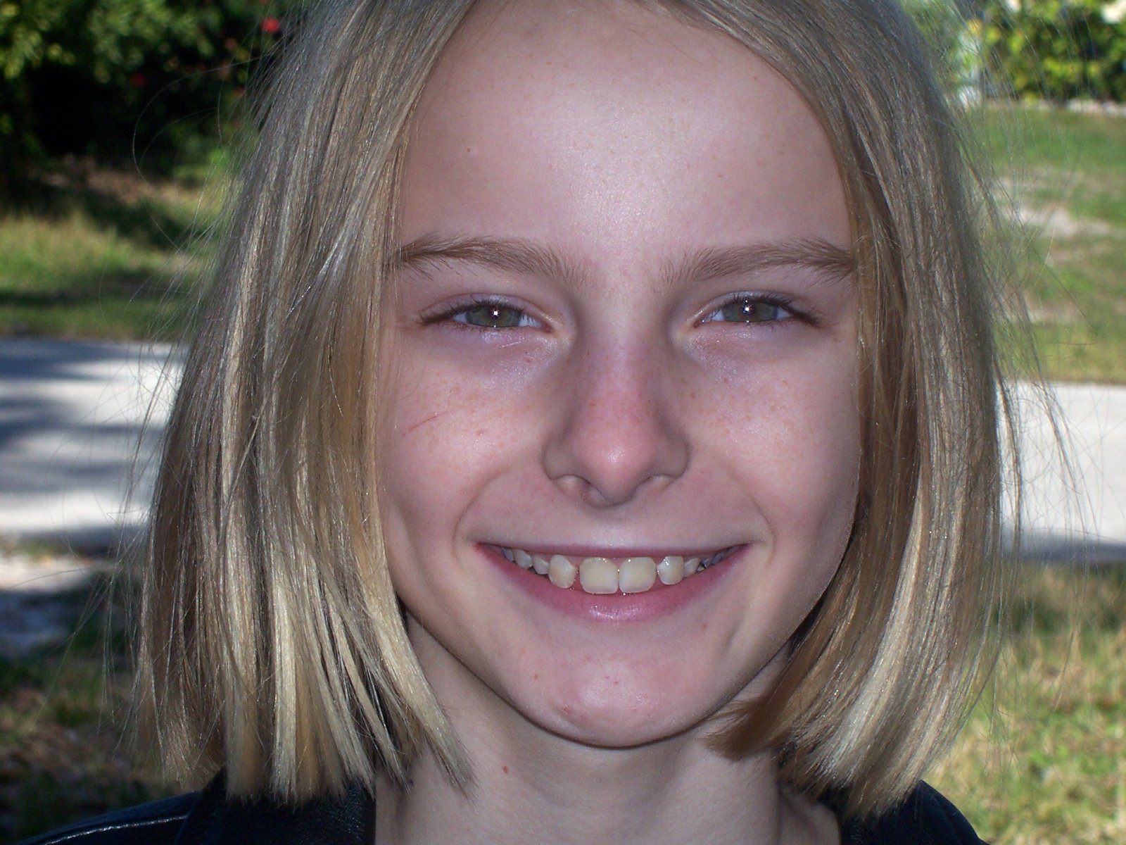 a young blond child with light blond hair smiling