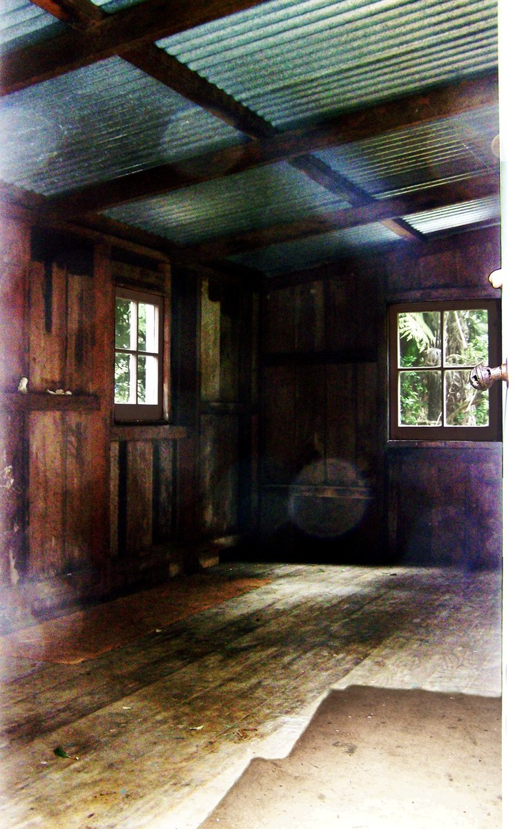 a empty room with wooden floors and a ceiling