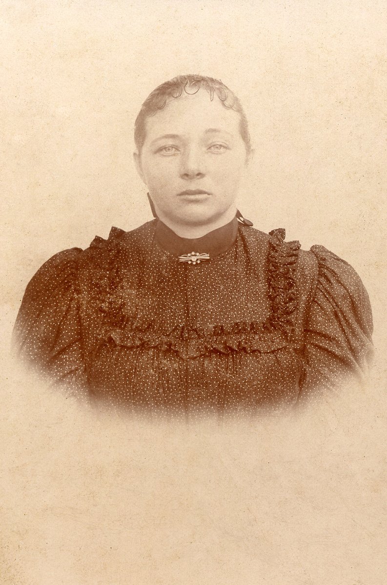 an old po of a woman who is looking into the camera