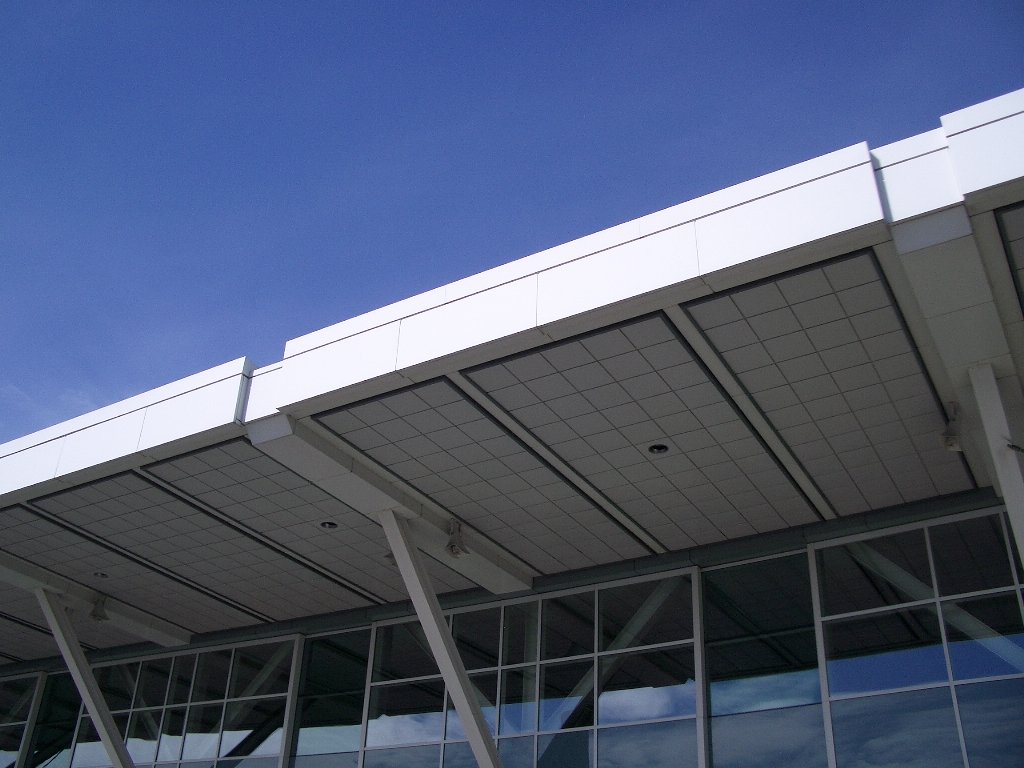 a view of a building with sky reflecting in the windows