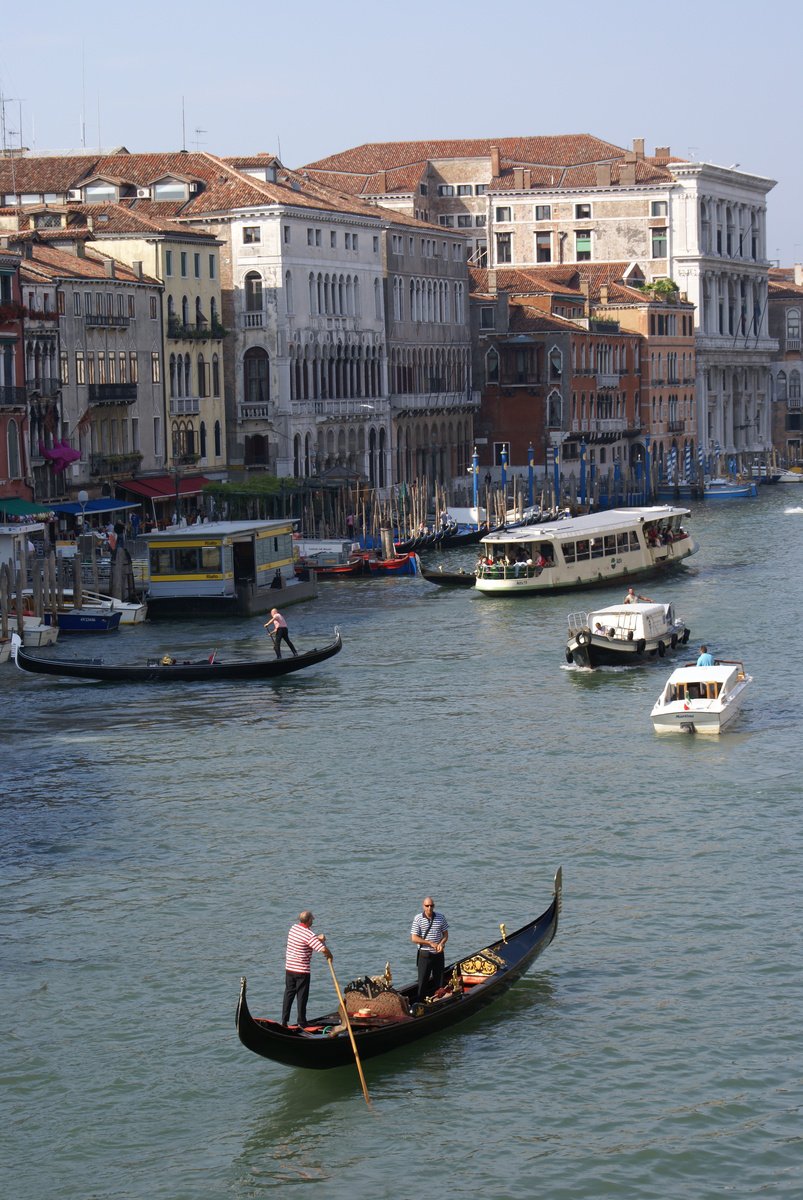 a group of people paddling small boats on water