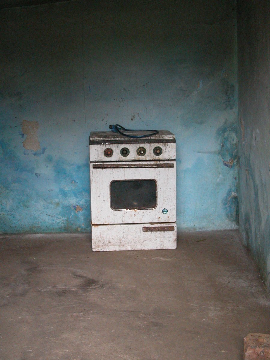 there is an old stove that is in a corner