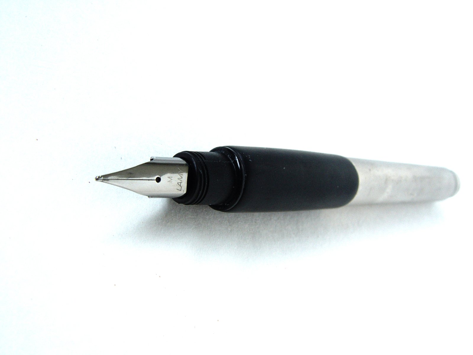 a black and silver pen with some black caps