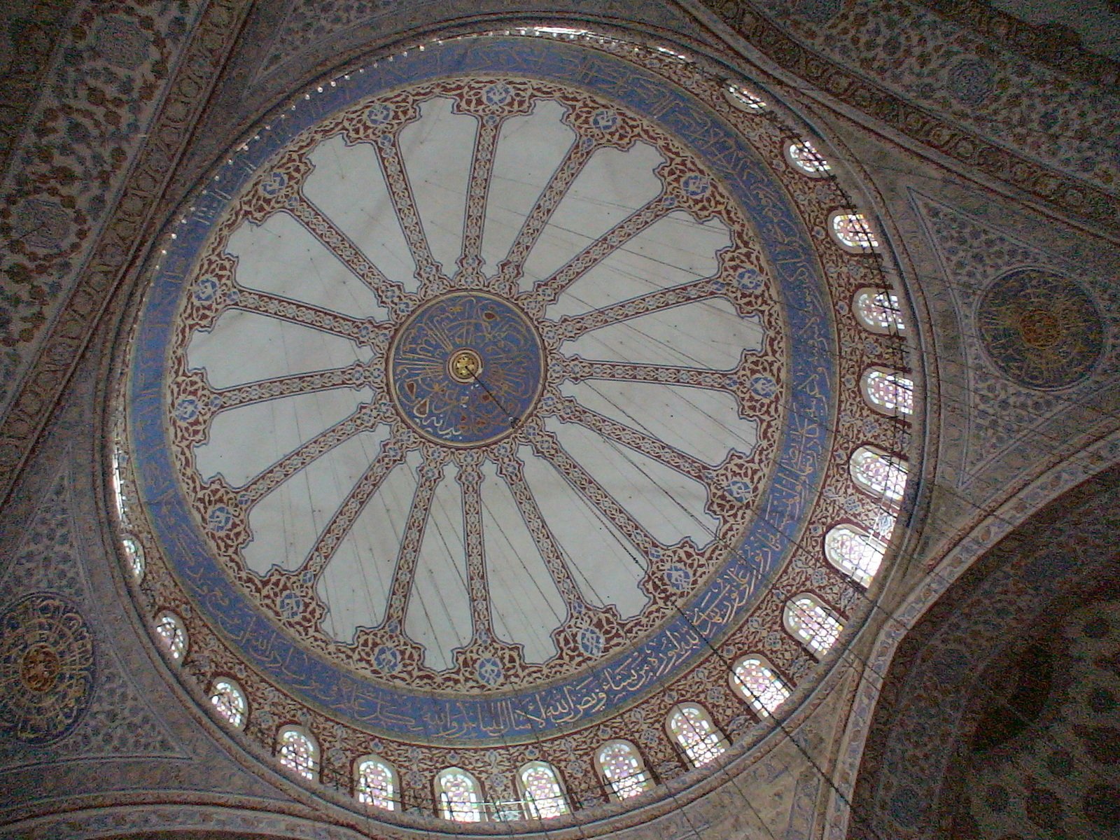 a dome in the middle of a building that has ornate designs and windows