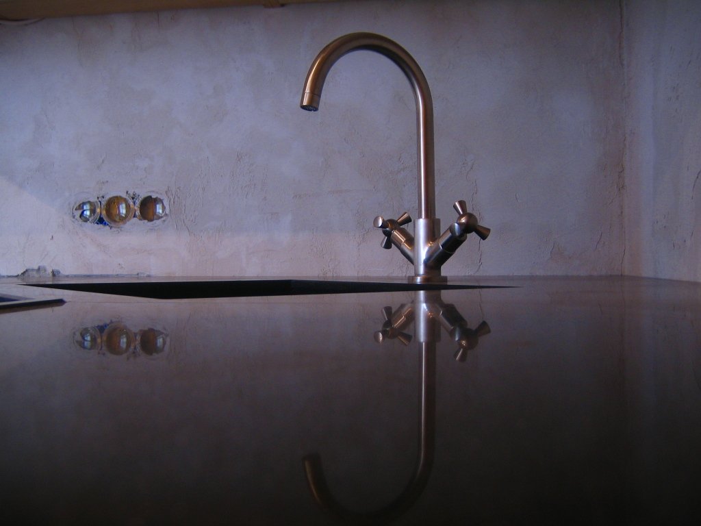 water flowing from a kitchen faucet on a counter