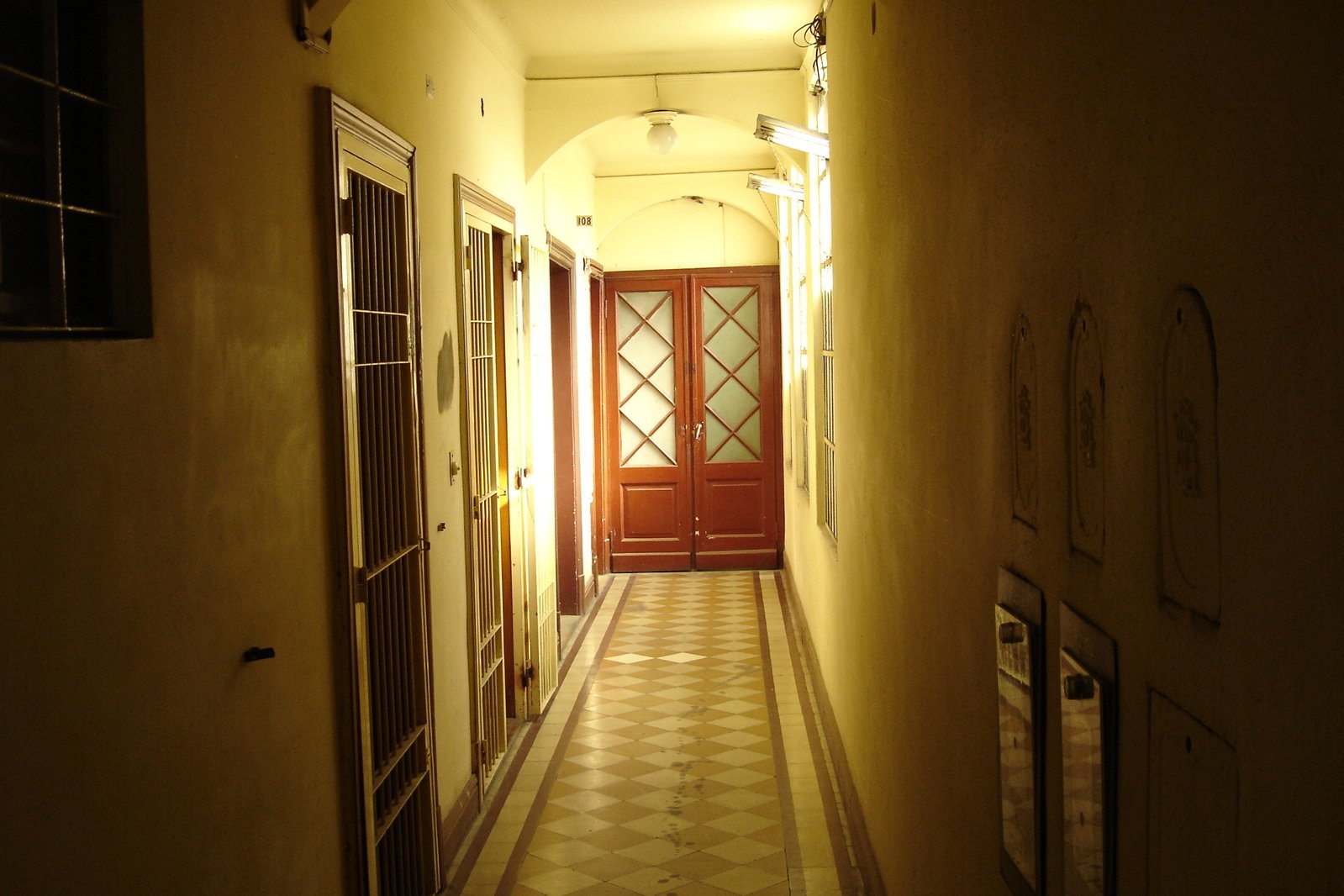 a long hallway with lights, door and windows