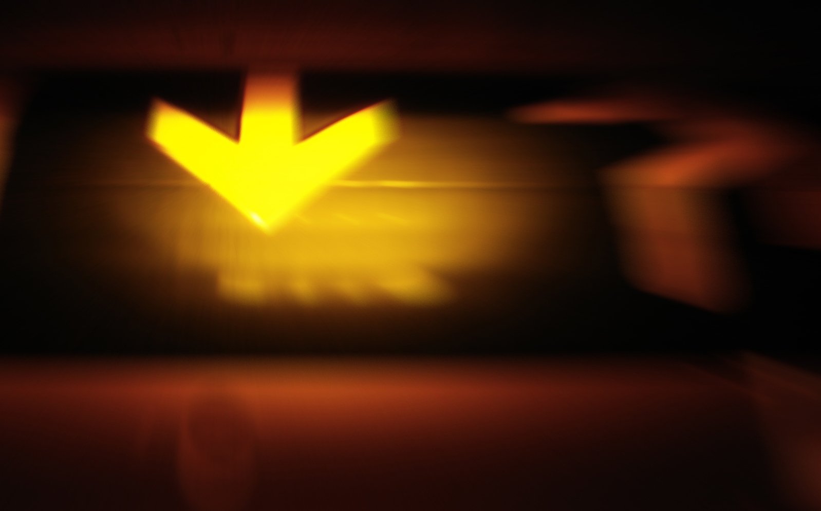 the blurry image shows a yellow arrow