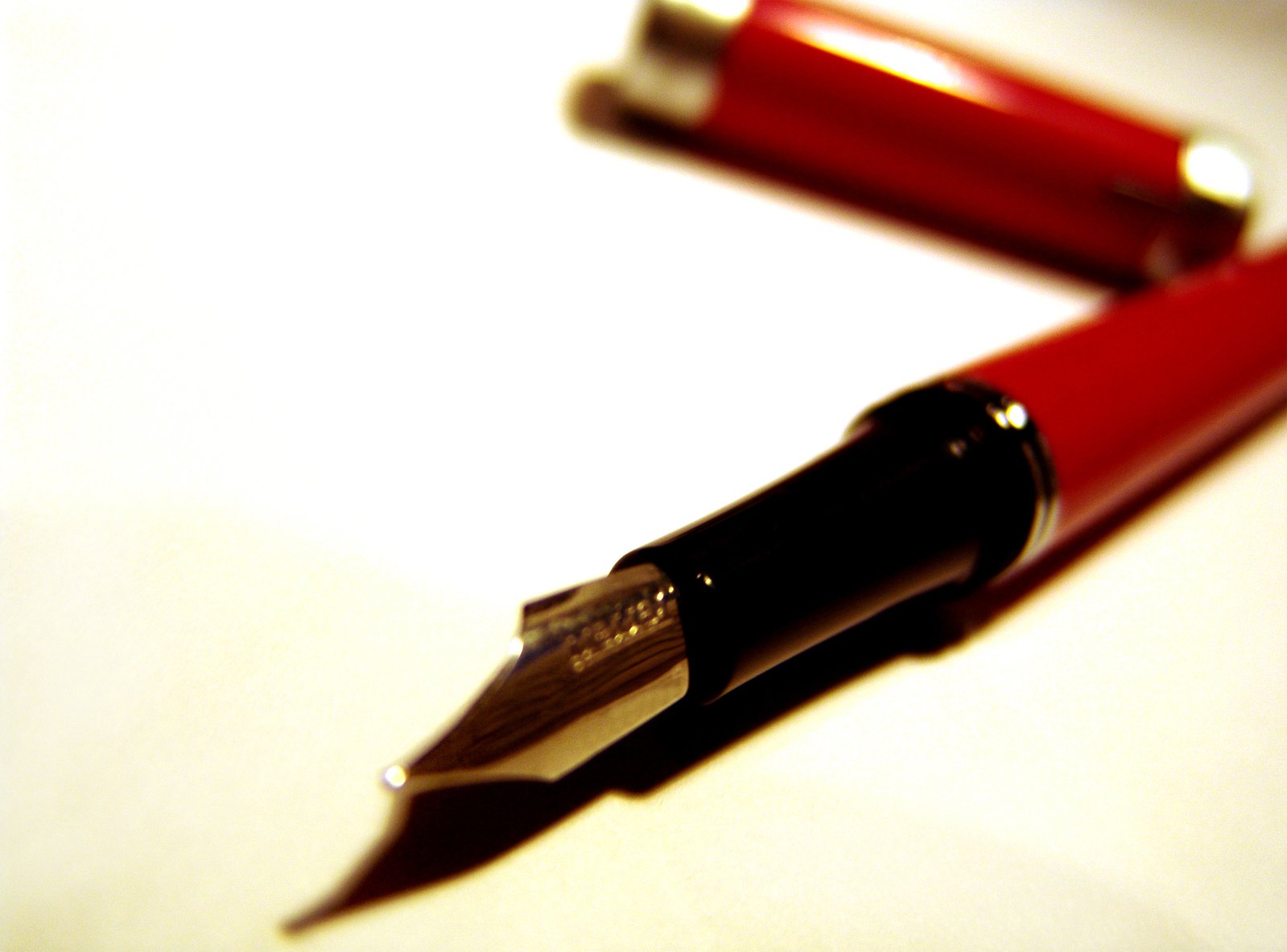 closeup of pen and two pens laying in opposite directions