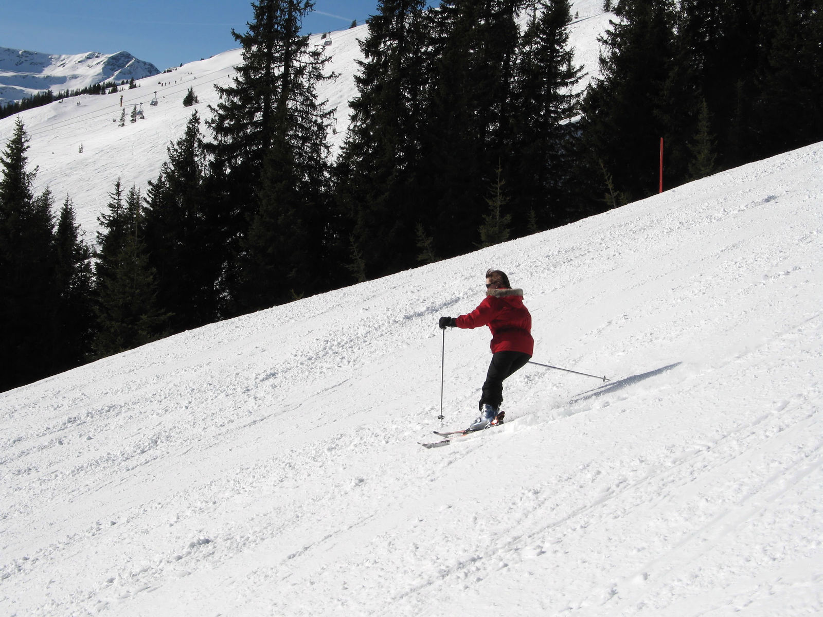 someone in red skiing down a mountain slope