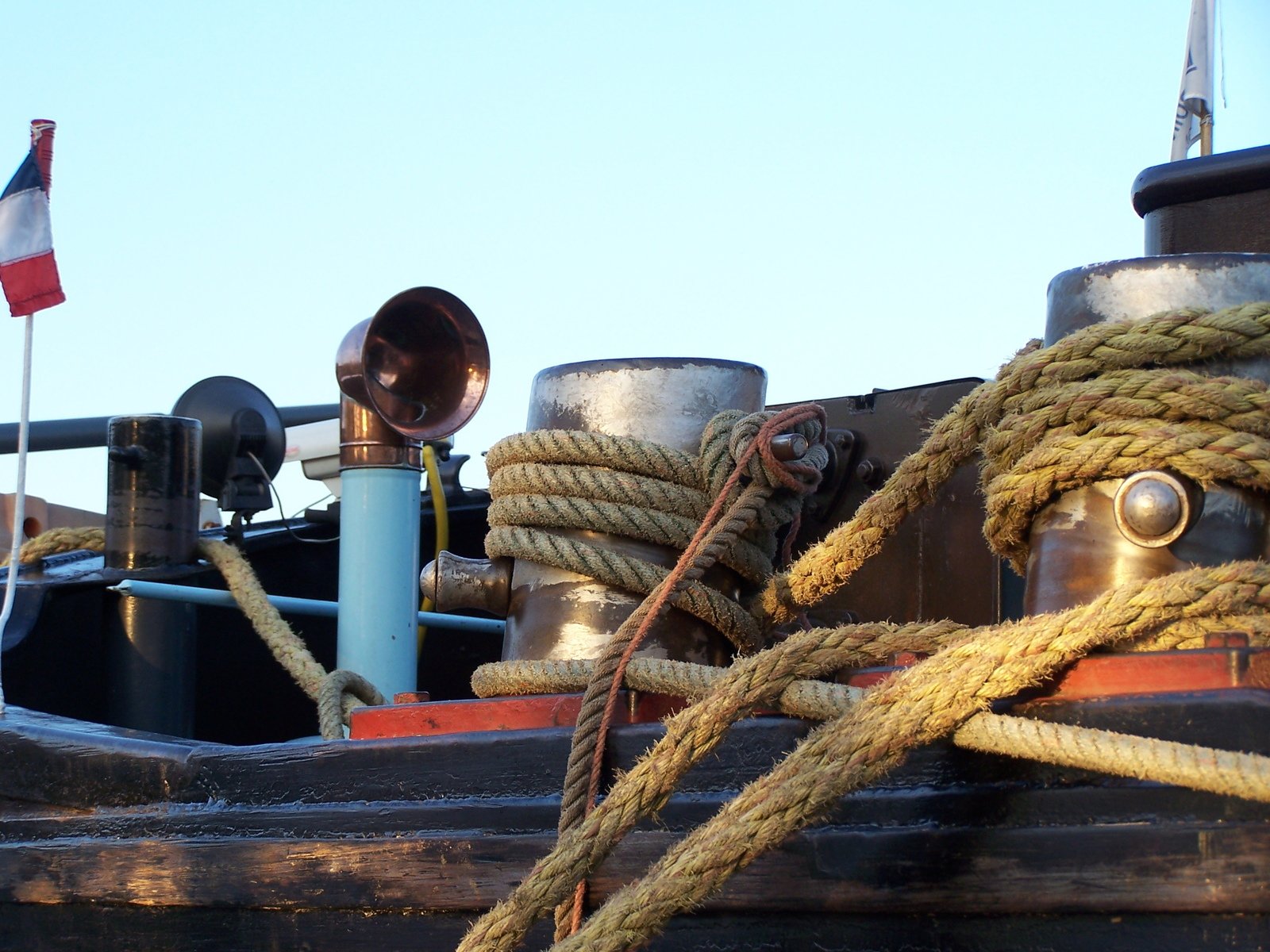 a close - up po of the ropes and poles on a ship