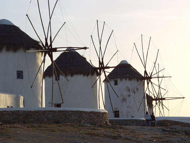two windmills that are outside on a hill