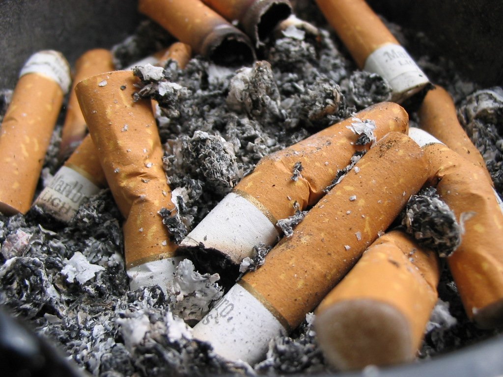 a pile of cigarettes that have been smoked