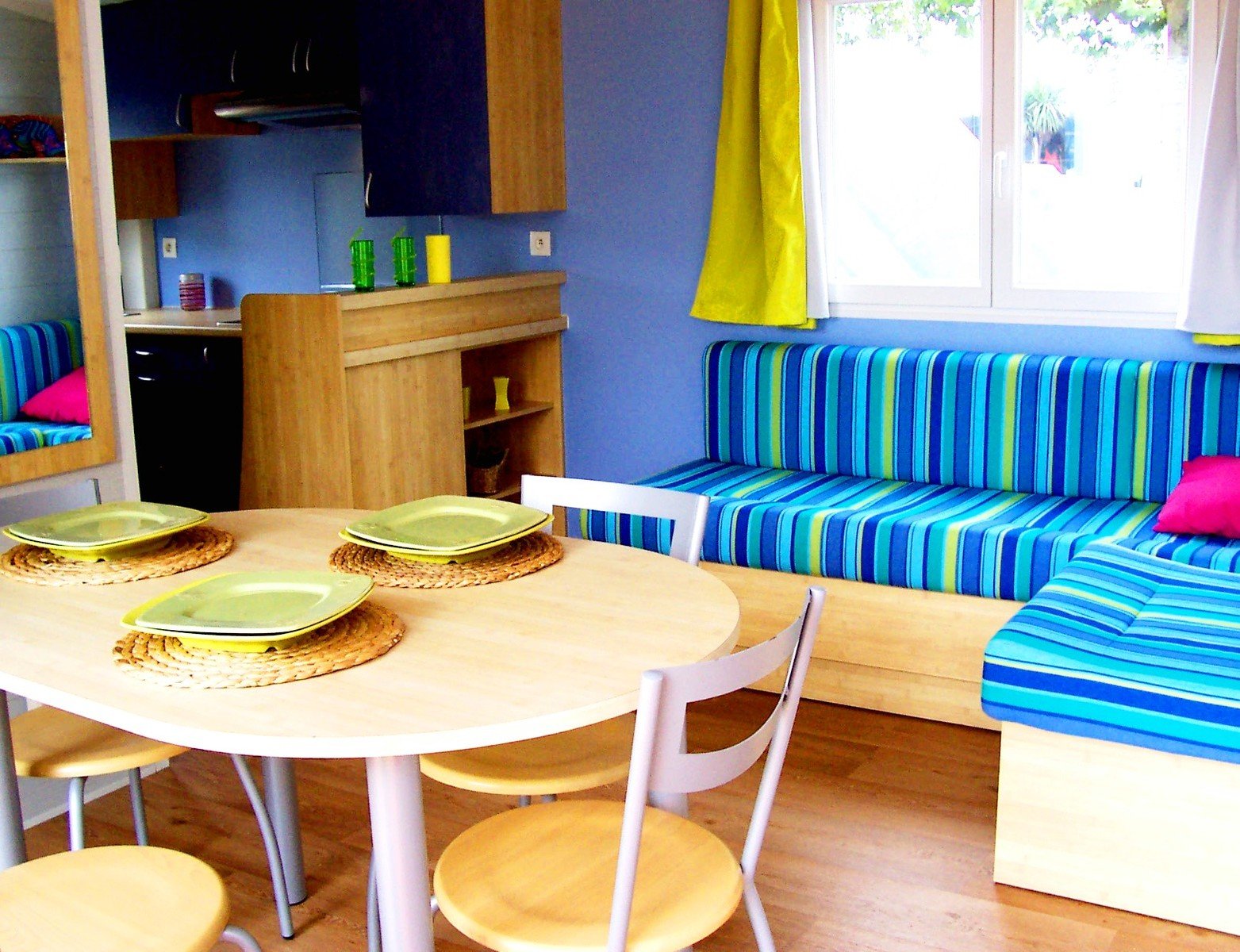 a blue living room with sofas and a dinning table