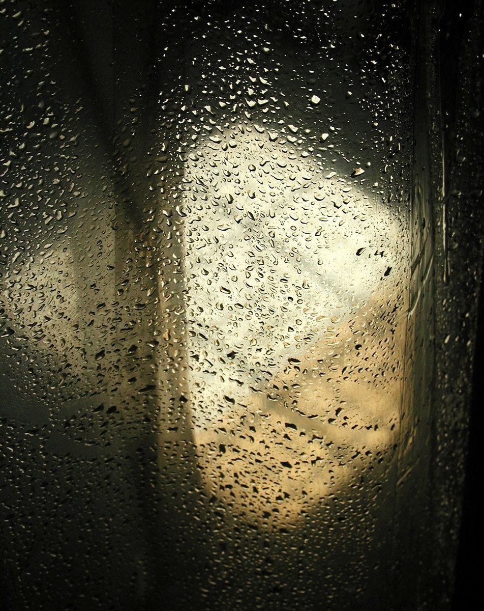 an image of the outside window with water drops