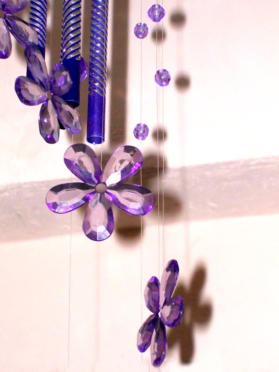 a wind catcher with crystal erflies and beads