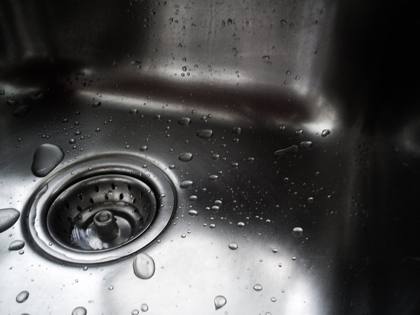 a stainless steel sink with water droplets