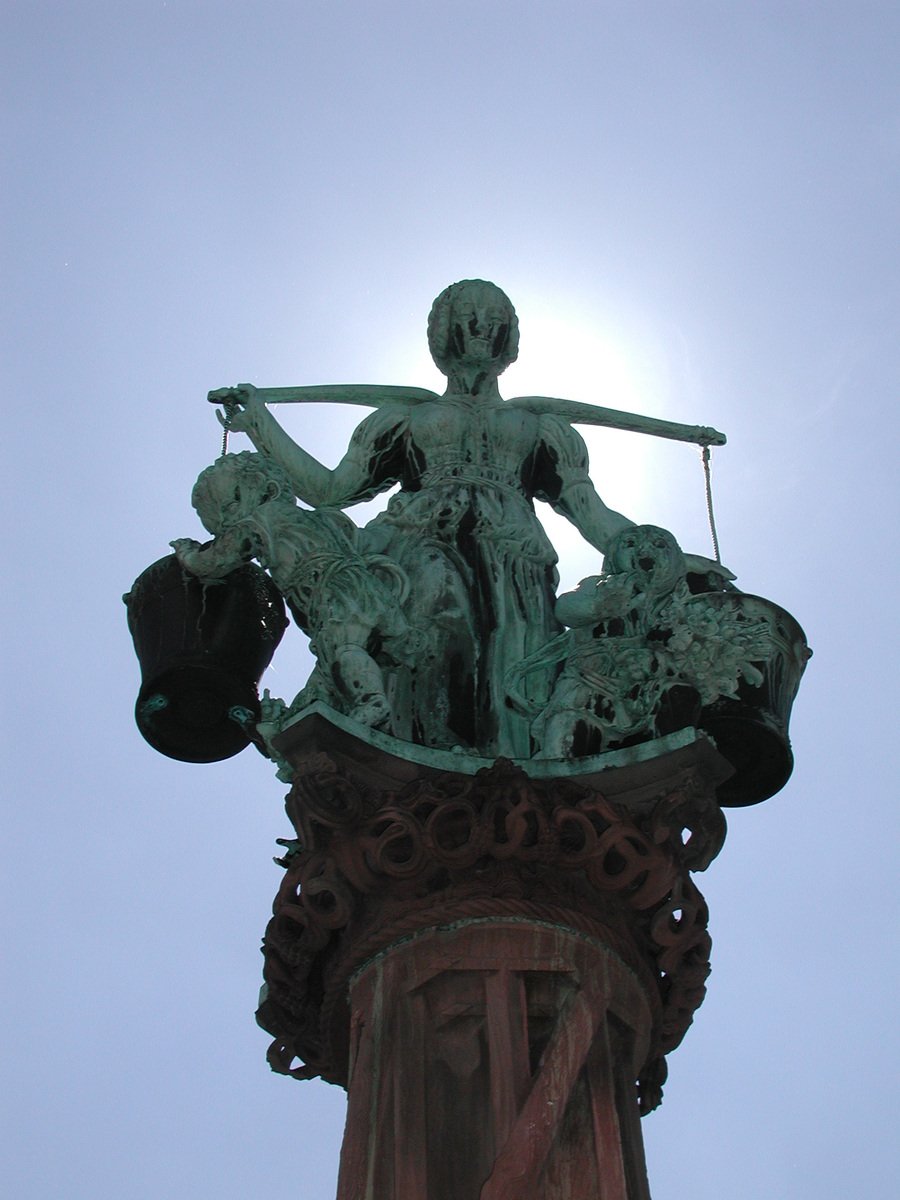 a statue is sitting on top of a building