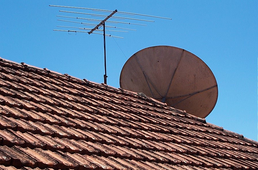 a brown satellite dish sitting on top of a roof