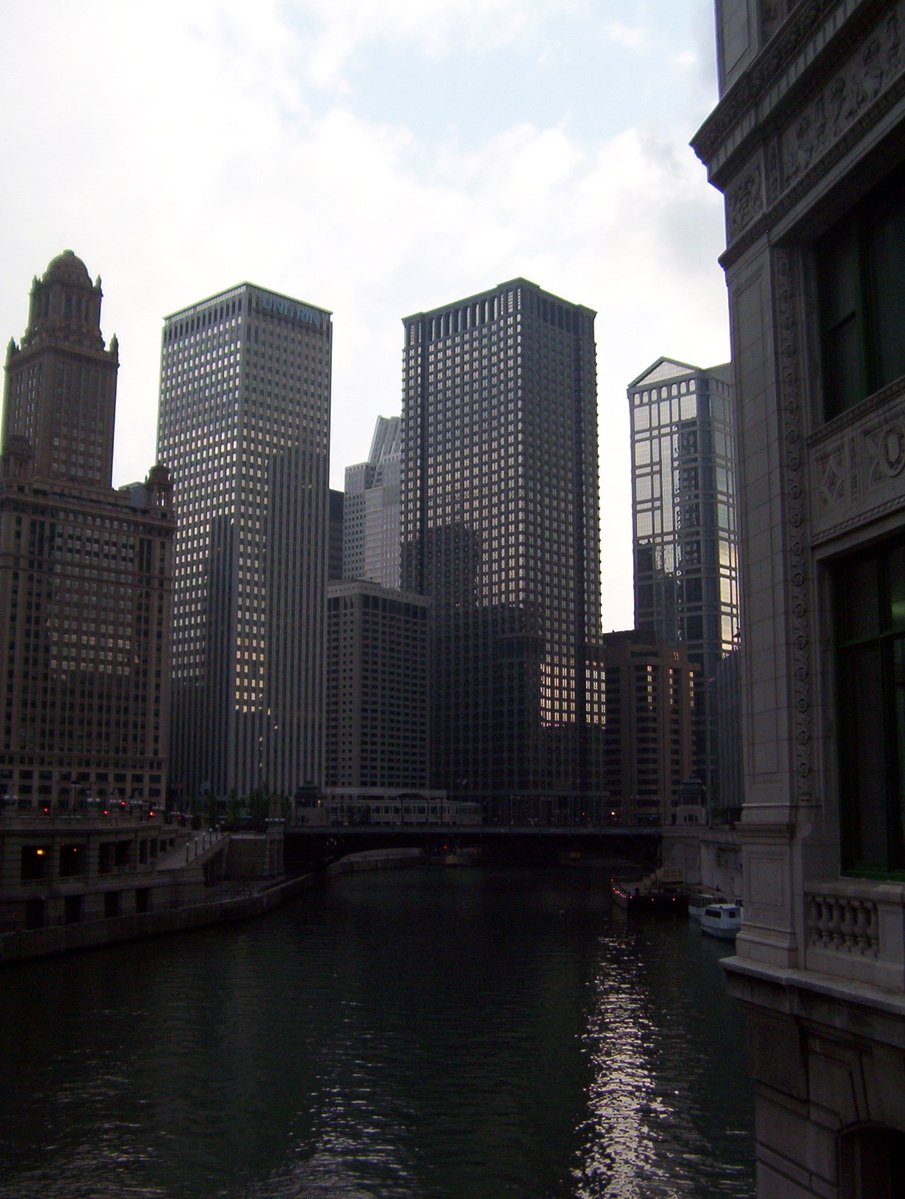 the view of a river with boats in it and skyscrs