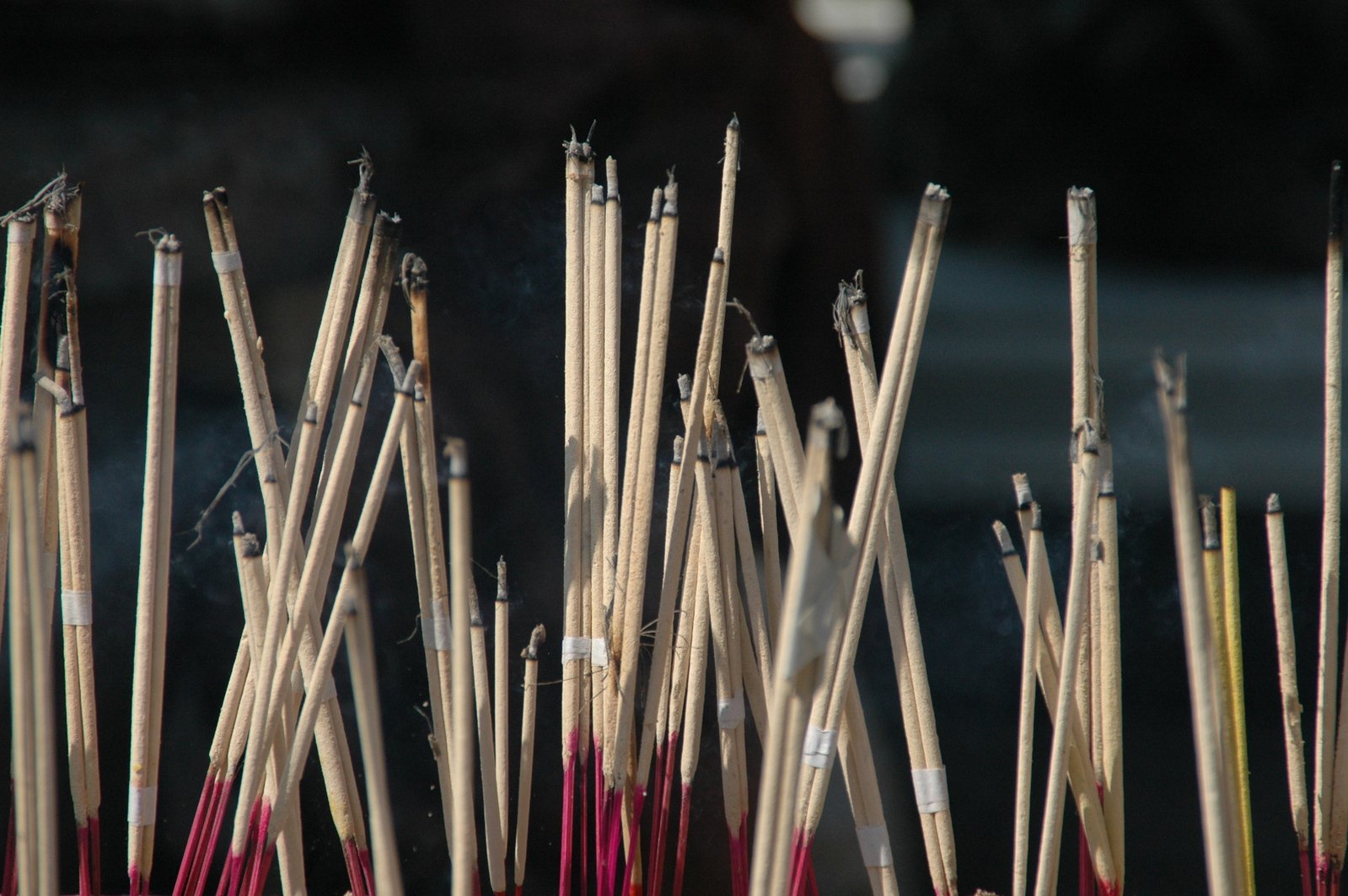 a pile of sticks with smoking stick holders attached to them