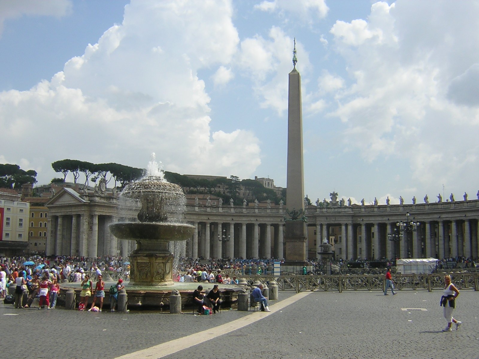 a large crowd stands outside in front of a tall building