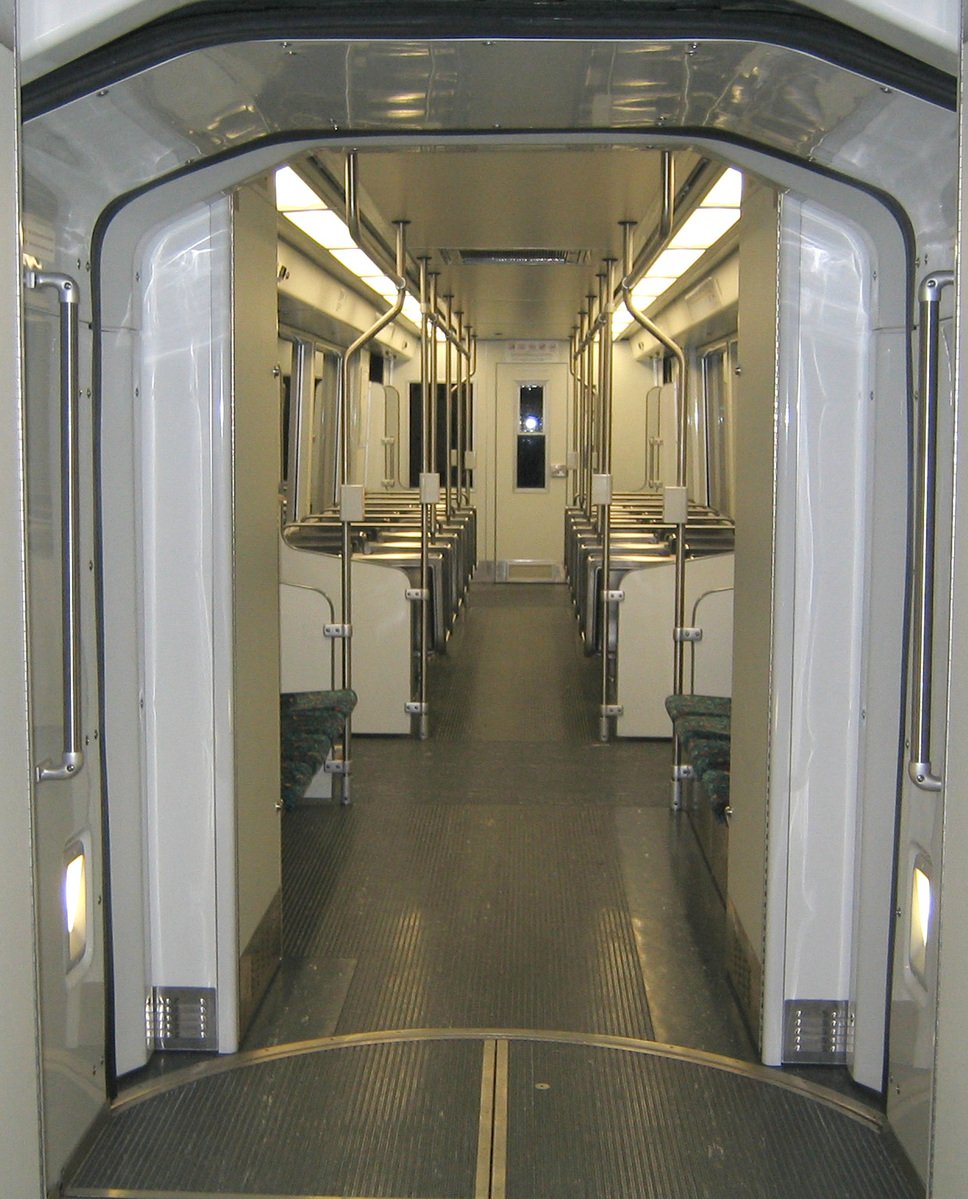 the subway train's interior has large pipes protruding from it