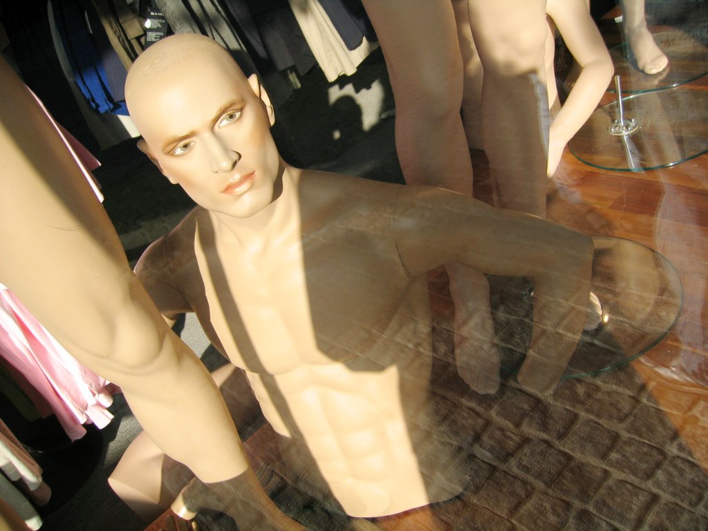 a mannequins standing with their heads close to the ground