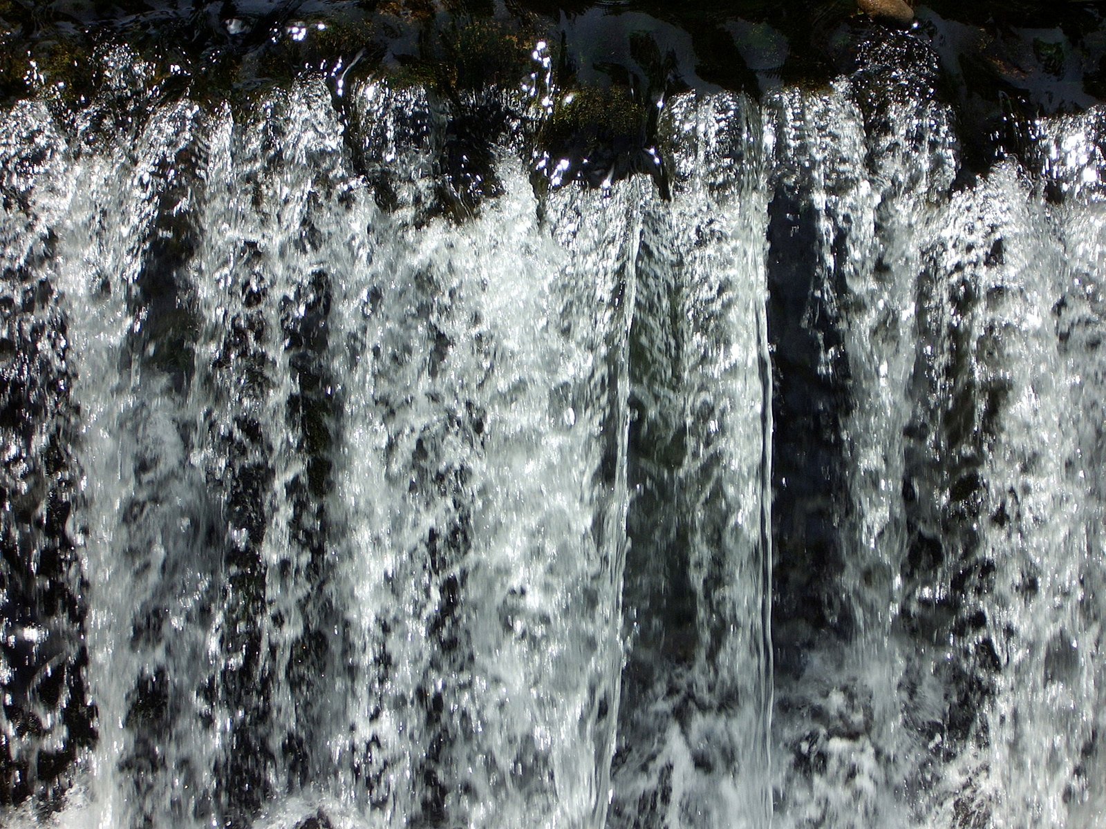 the water pouring from the side of a wall