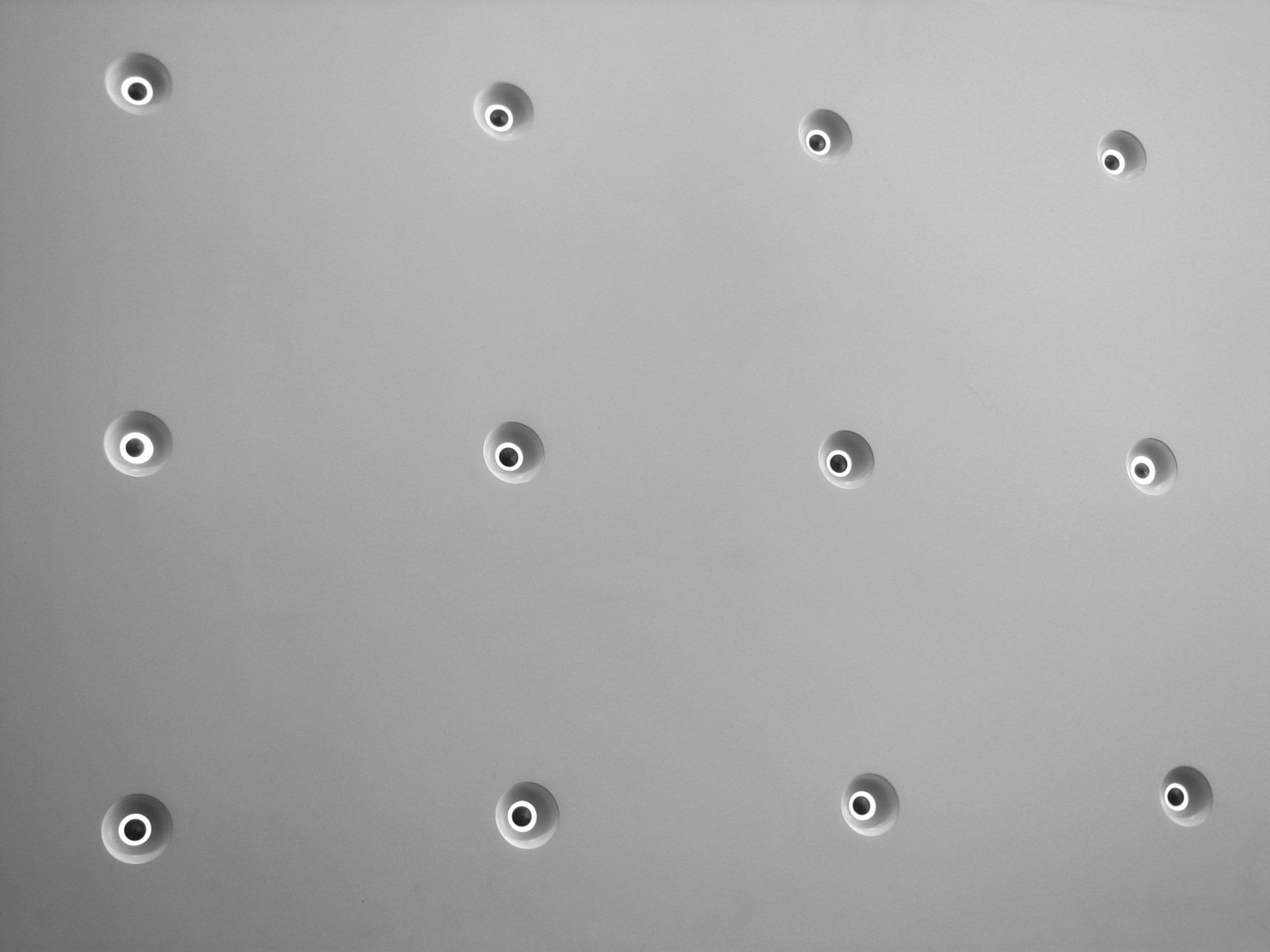 a stainless steel surface has bullet holes in it