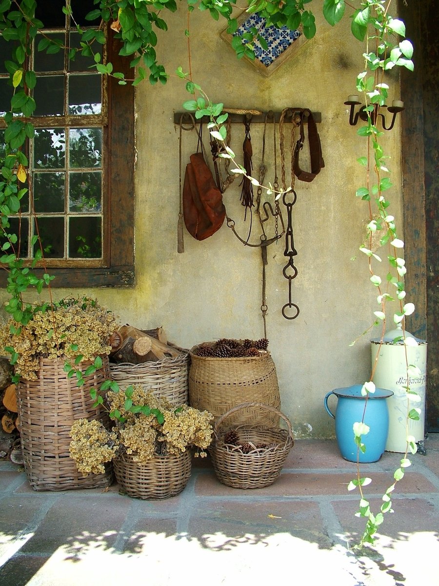 several pots and baskets in front of a house