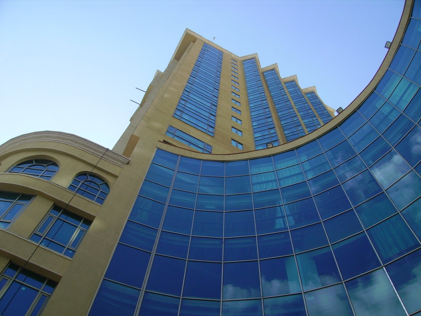 large blue and beige building with circular window in center