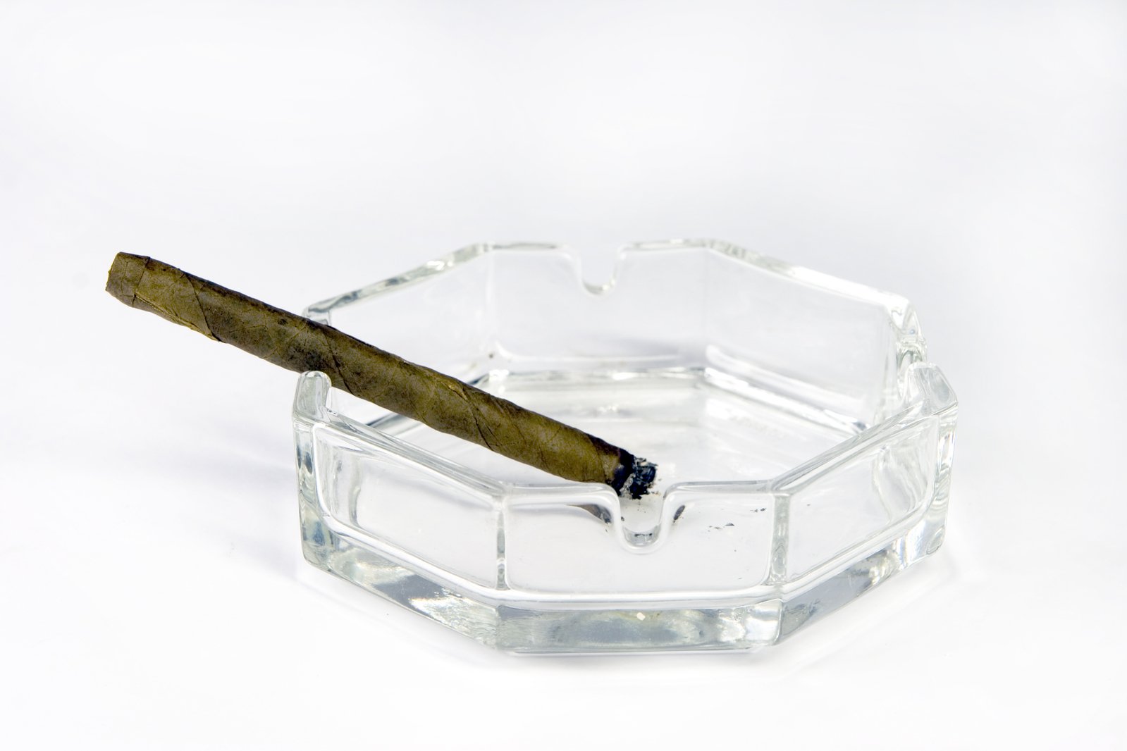 cigar with no mantle and one side open in a small clear ash container