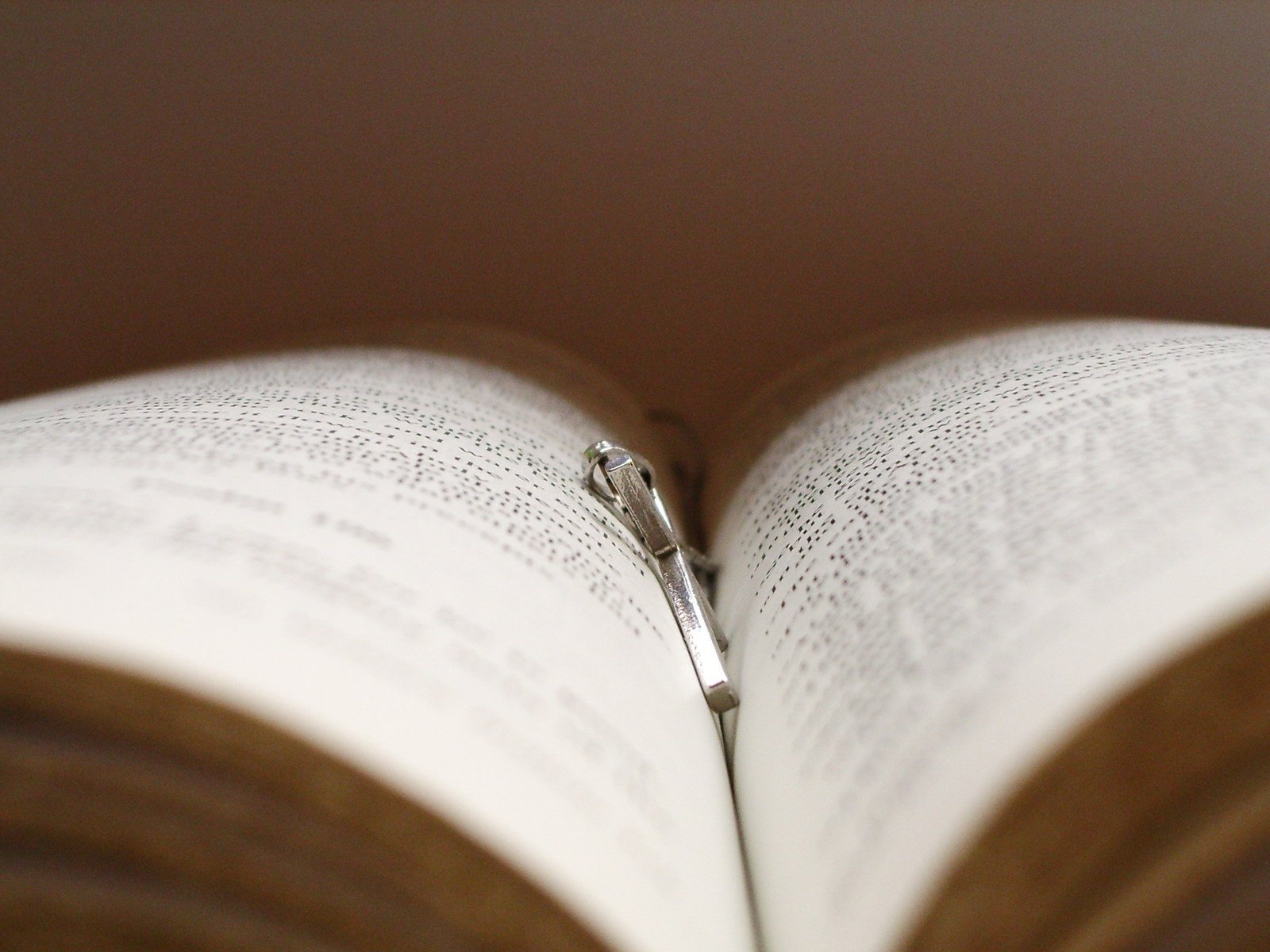 the pages of a book are open with a metal zipper