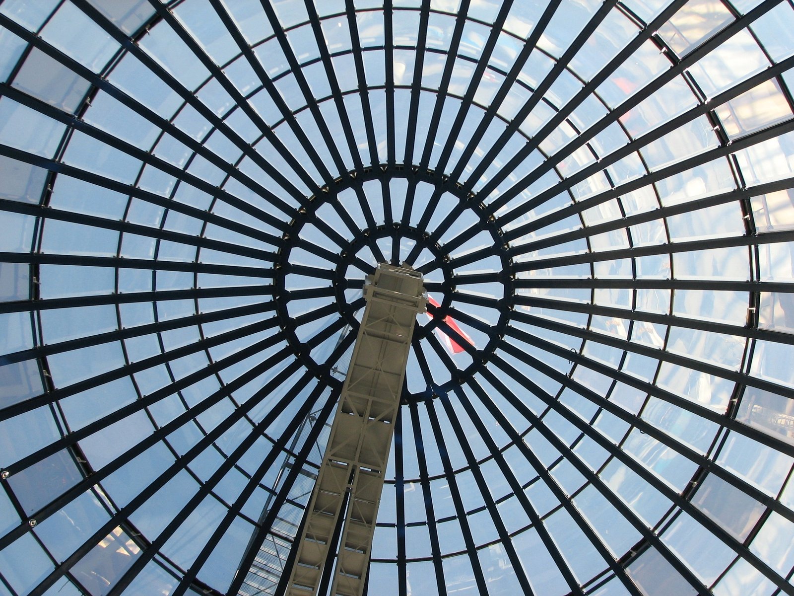 the inside of a glass building looking up at it