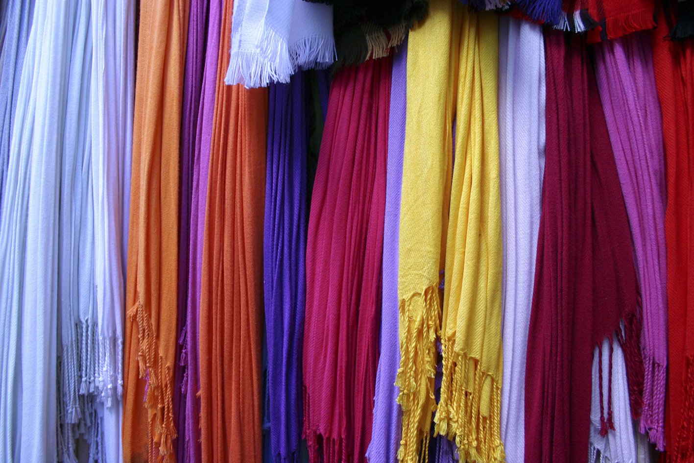 colorful scarfs with fringe are on display
