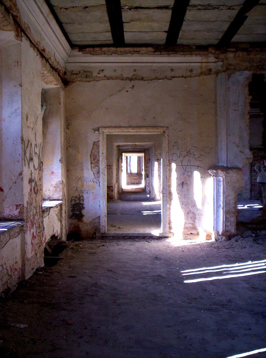 an old, run down corridor between two large rooms