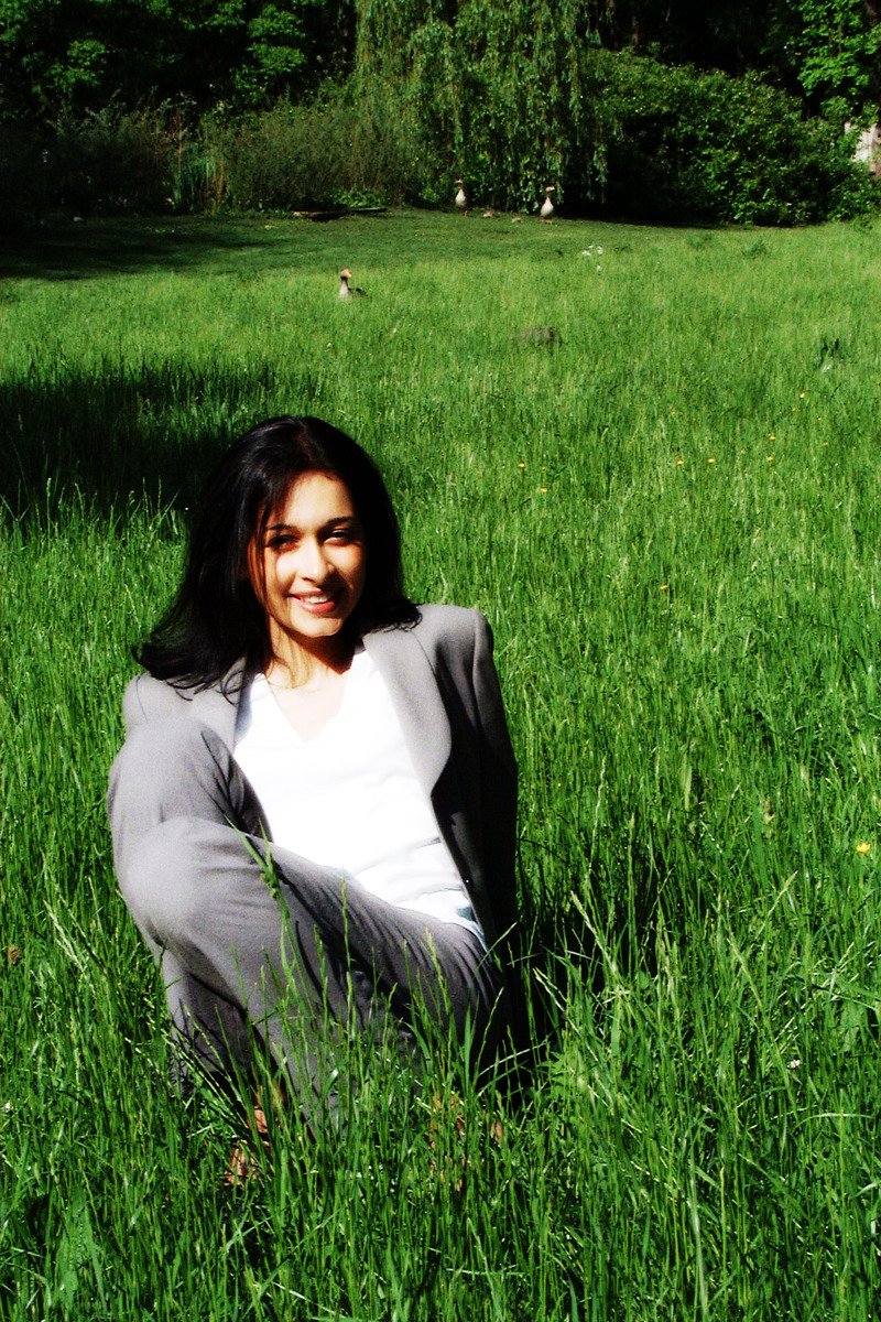 a woman posing in the middle of tall grass