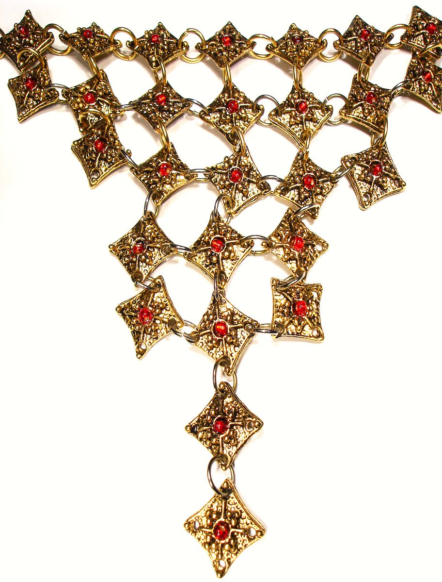 a gold necklace set with many red stones