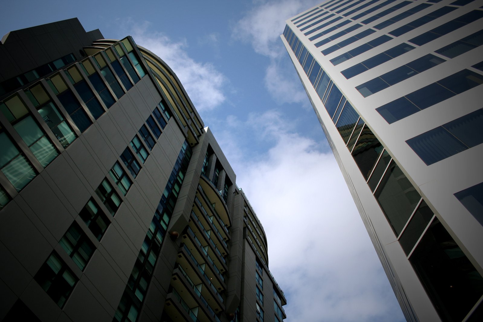 tall buildings with windows and sky view from the ground