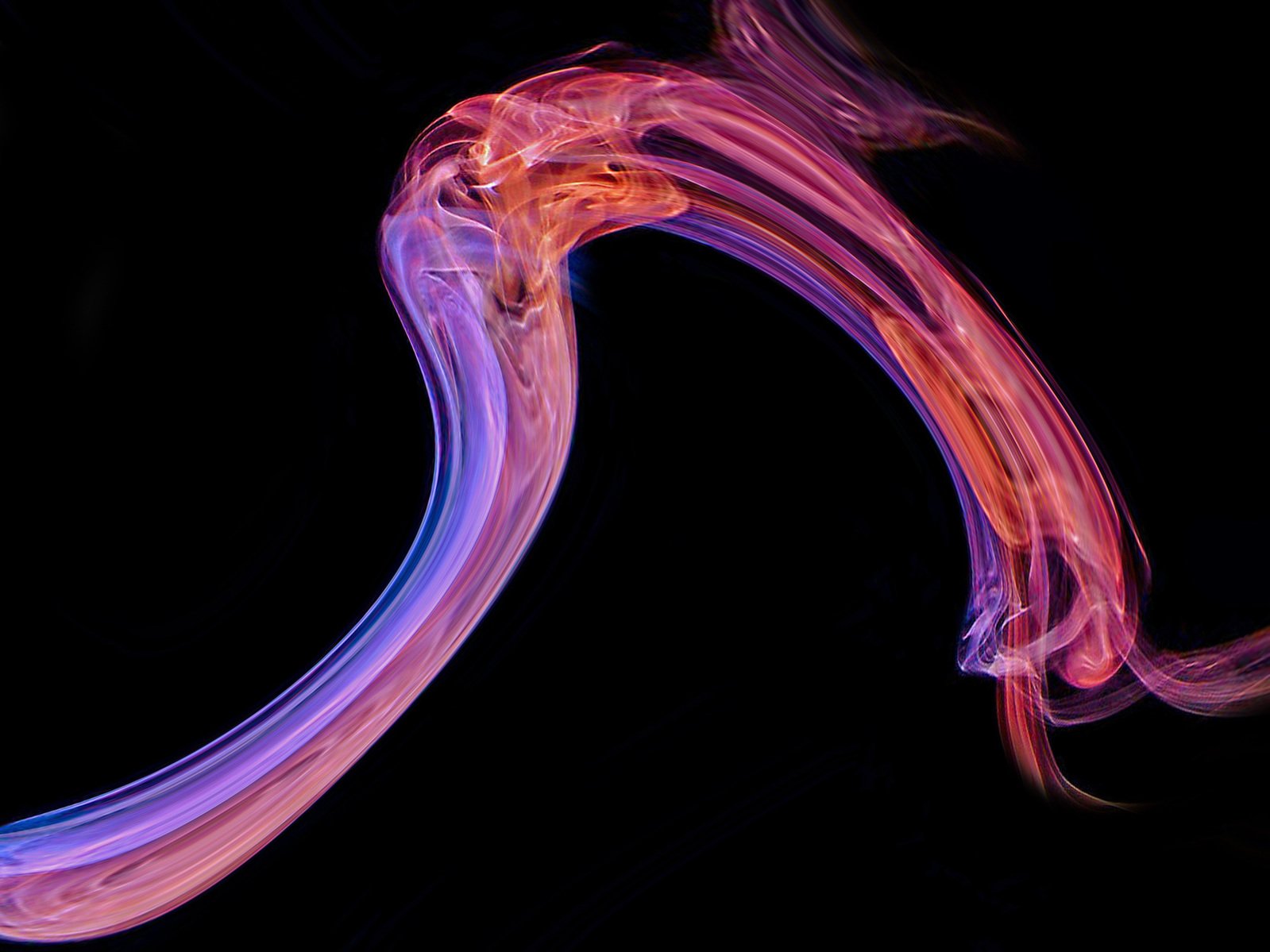long exposure pograph of bright pink smoke against black background