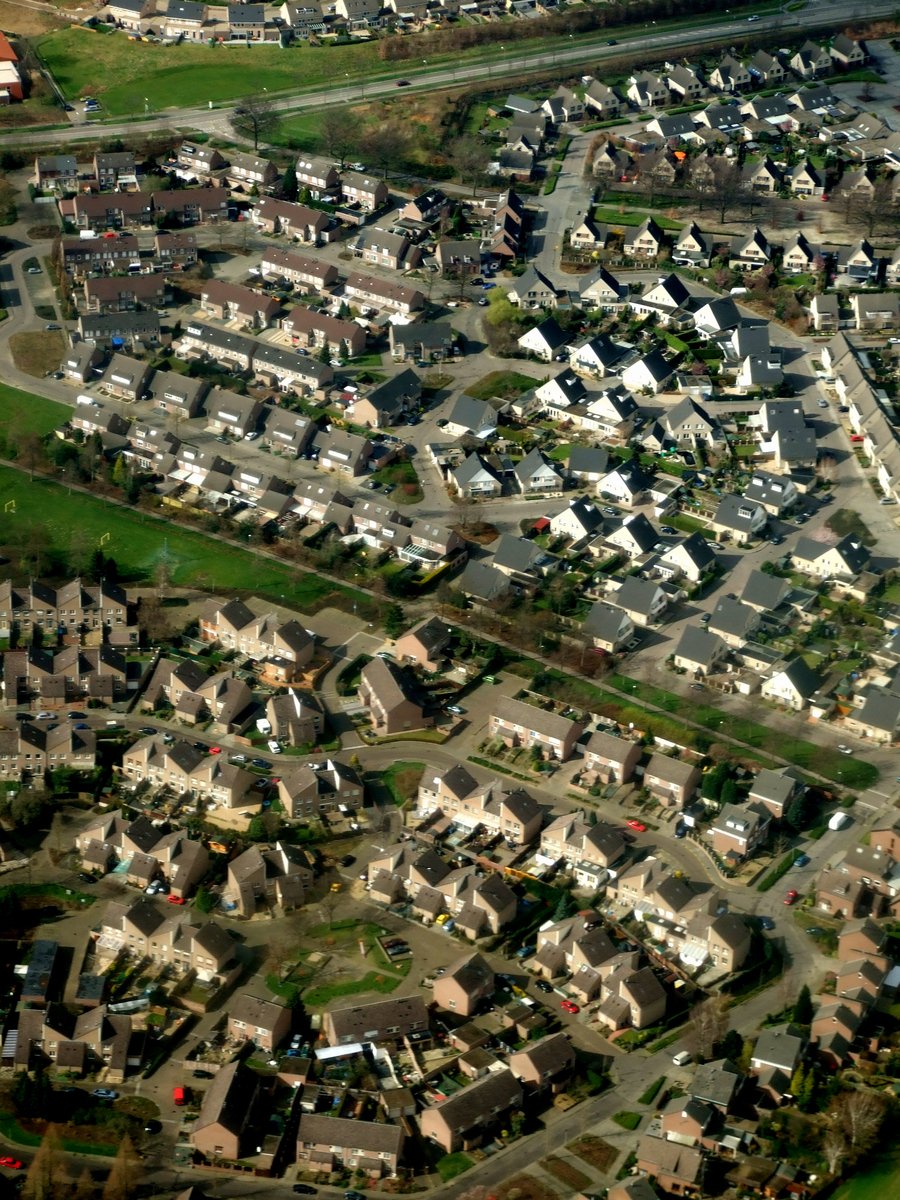 an aerial po of residential houses by the river