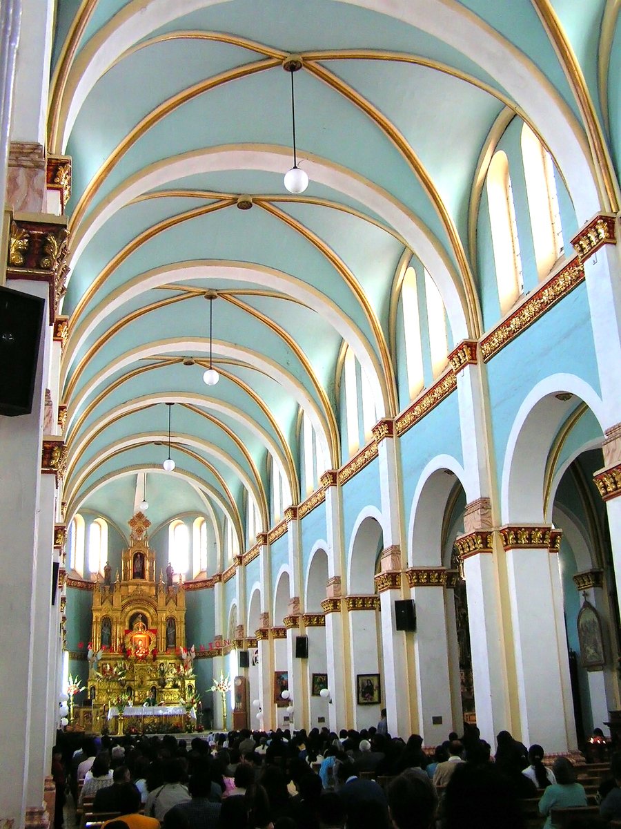 a crowd of people inside of a cathedral