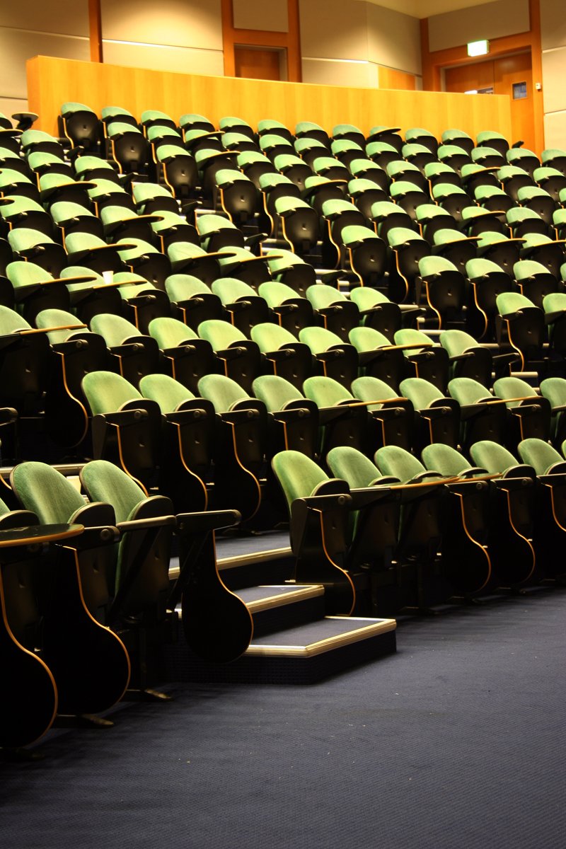 empty seats and wooden chairs in an auditorium