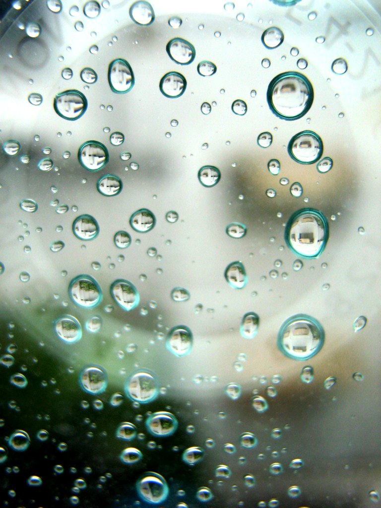 water drops are floating on the glass and inside of a large bowl