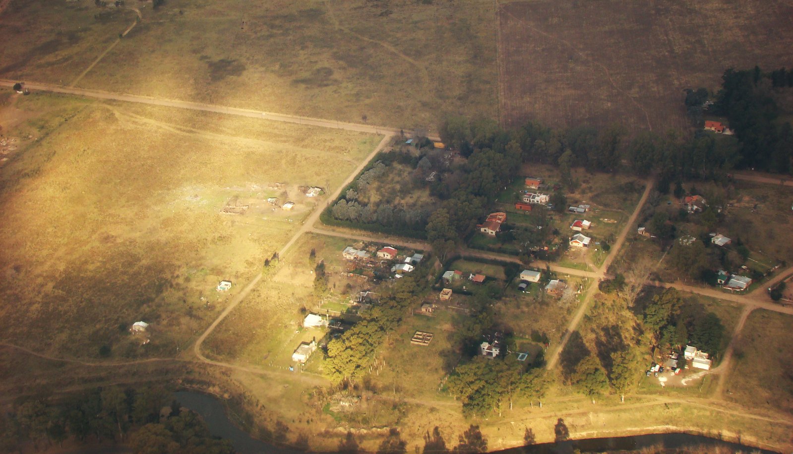a po from an airplane shows the area of some buildings and fields