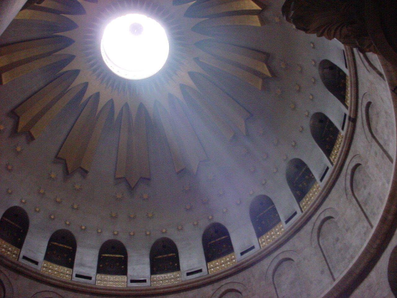 a sun shines through the hole in a dome