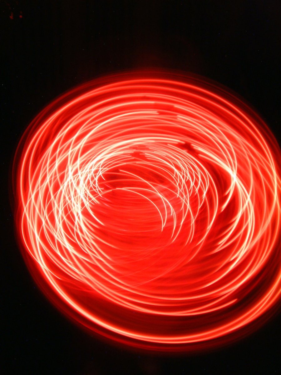 a circular of light streaks on top of black paper